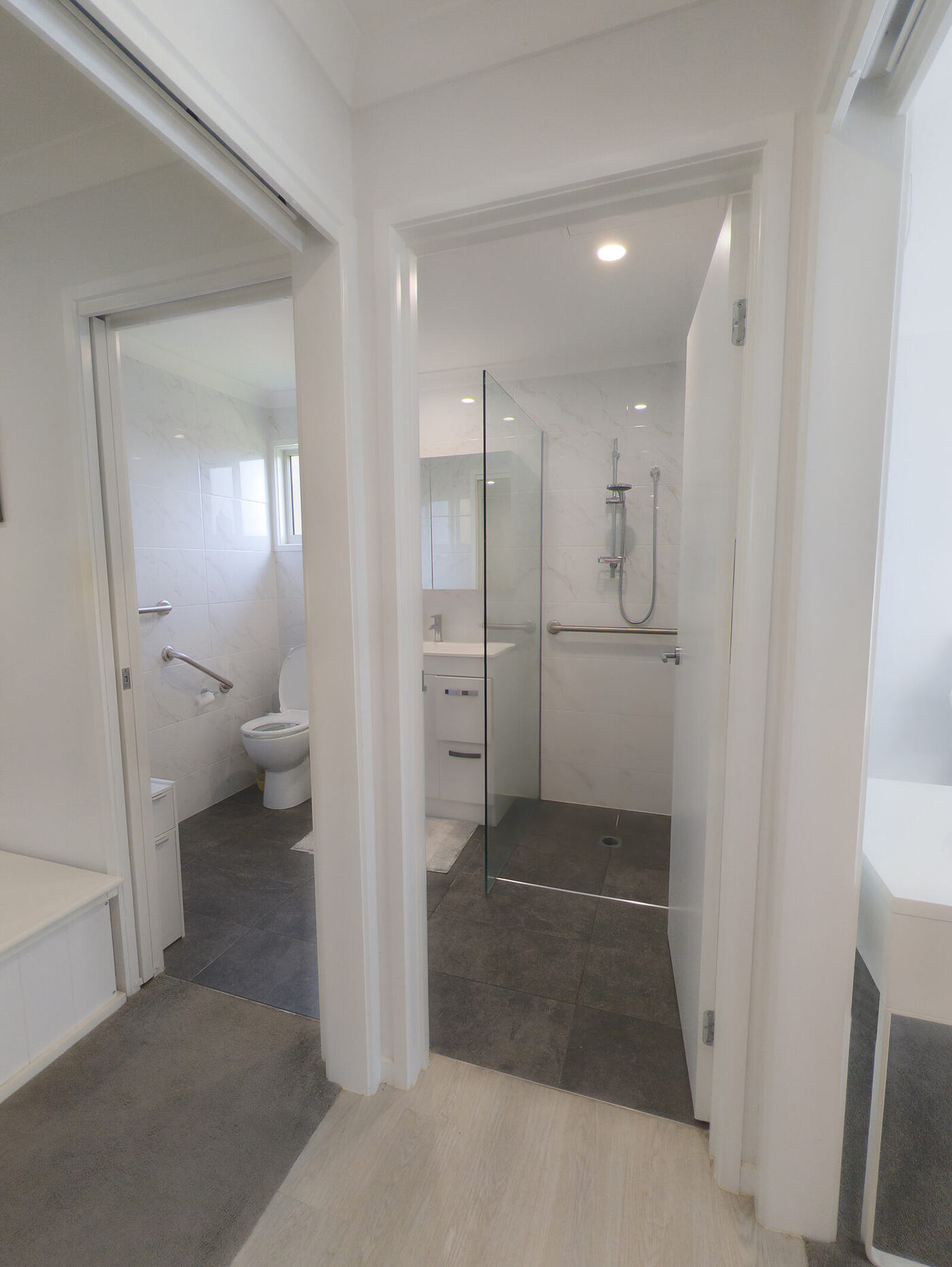 Accessible bathroom with grab rails and a level-entry shower